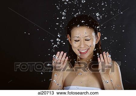 Woman splashing her face with water View Large Photo Image Stock Image - Woman splashing her face with water. Fotosearch