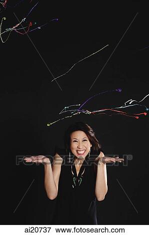 Woman with hands up, streamers flying in air View Large Photo Image Stock Photo - Woman with hands up, streamers flying in air. Fotosearch