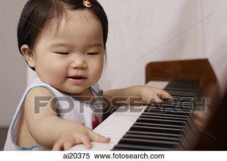 Young girl playing the piano View Large Photo Image Stock Photography - Young girl playing the piano. Fotosearch