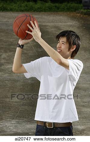 Young man holding basketball, aiming View Large Photo Image Stock Photo - Young man holding basketball, aiming. Fotosearch