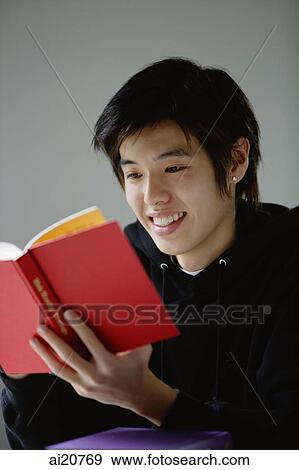Young man reading book View Large Photo Image Stock Photo - Young man reading book. Fotosearch