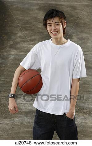 Young man with basketball, hand in pocket View Large Photo Image Stock Photo - Young man with basketball, hand in pocket. Fotosearch