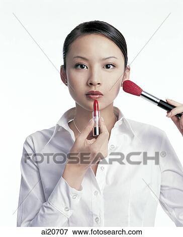 Young woman applying make-up View Large Photo Image Stock Photo - Young woman applying make-up. Fotosearch