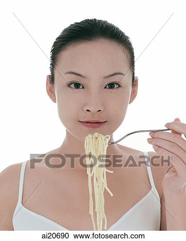 Young woman eating spaghetti View Large Photo Image Stock Image - Young woman eating spaghetti. Fotosearch