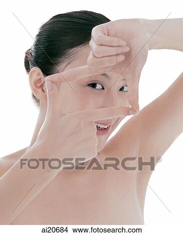 Young woman, hair pulled back, making finger frame View Large Photo Image Picture - Young woman, hair pulled back, making finger frame. Fotosearch