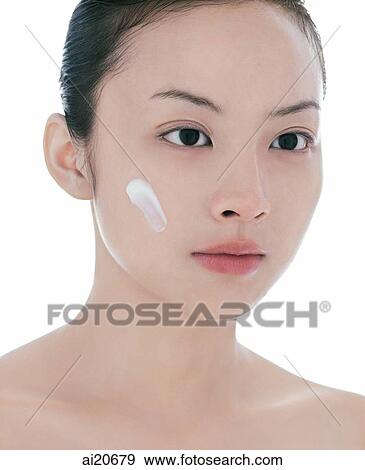 Young woman, head shot, dab of moisturizer on face View Large Photo Image Stock Photo - Young woman, head shot, dab of moisturizer on face. Fotosearch