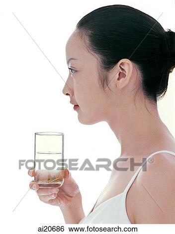 Young woman holding a glass of water, profile View Large Photo Image Stock Photograph - Young woman holding a glass of water, profile. Fotosearch