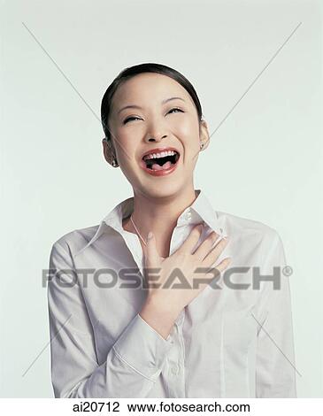 Young woman laughing, hand on chest View Large Photo Image Stock Image - Young woman laughing, hand on chest. Fotosearch