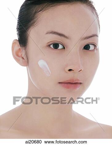 Young woman looking at camera, dab of moisturizer on face View Large Photo Image Stock Image - Young woman looking at camera, dab of moisturizer on face. Fotosearch