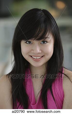 Young woman looking at camera, portrait View Large Photo Image Stock Image - Young woman looking at camera, portrait. Fotosearch