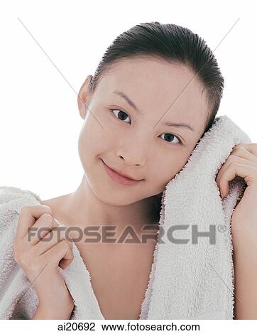 Young woman looking at camera, wiping face with towel View Large Photo Image Stock Image - Young woman looking at camera, wiping face with towel. Fotosearch