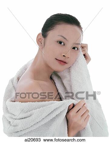 Young woman looking at camera, wrapped in a towel View Large Photo Image Stock Image - Young woman looking at camera, wrapped in a towel. Fotosearch