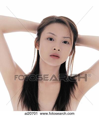 Young woman with long straight hair, hands behind head View Large Photo Image Stock Image - Young woman with long straight hair, hands behind head. Fotosearch