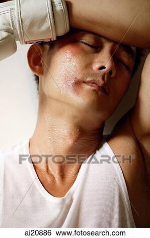 Boxer wearing boxing glove, hand on head, eyes closed View Large Photo Image Stock Photograph - Boxer wearing boxing glove, hand on head, eyes closed. Fotosearch