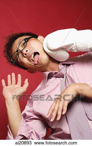Businessman being punched by boxing glove View Large Photo Image Stock Image - Businessman being punched by boxing glove. Fotosearch