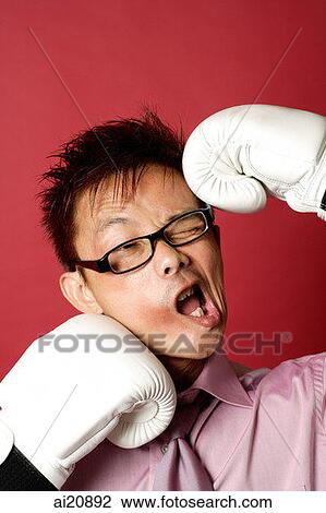 Businessman being punched with boxing gloves View Large Photo Image Stock Image - Businessman being punched with boxing gloves. Fotosearch