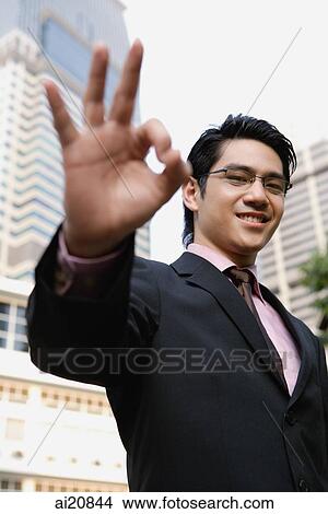 Businessman making hang sign View Large Photo Image Picture - Businessman making hang sign. Fotosearch