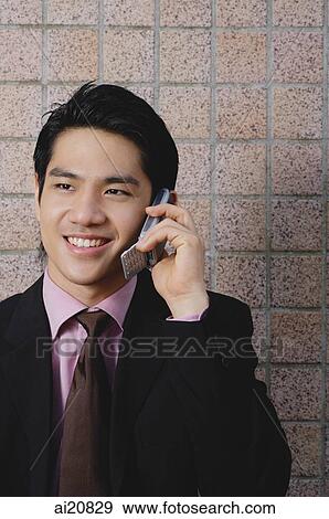 Businessman using mobile phone View Large Photo Image Stock Photo - Businessman using mobile phone. Fotosearch