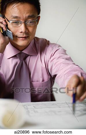 Stock Photograph - Businessman using mobile phone. Fotosearch