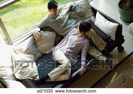 Couple at home in living room, high angle view View Large Photo Image Stock Image - Couple at home in living room, high angle view. Fotosearch