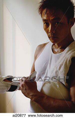 Male boxer putting on boxing gloves View Large Photo Image Stock Photo - Male boxer putting on boxing gloves. Fotosearch