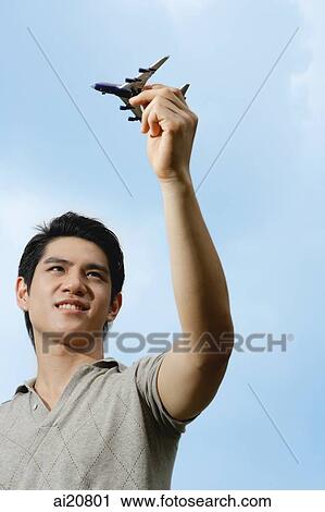 Man holding toy airplane View Large Photo Image Stock Image - Man holding toy airplane. Fotosearch