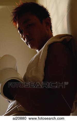 Man leaning on wall, boxing gloves on hand, looking down View Large Photo Image Stock Image - Man leaning on wall, boxing gloves on hand, looking down. Fotosearch