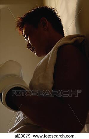 Man leaning on wall, boxing gloves on hand View Large Photo Image Stock Photo - Man leaning on wall, boxing gloves on hand. Fotosearch