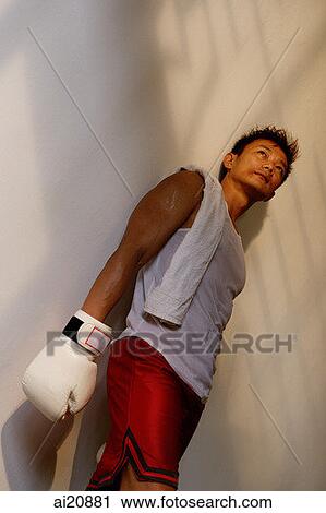 Man wearing boxing gloves, standing, looking away View Large Photo Image Stock Image - Man wearing boxing gloves, standing, looking away. Fotosearch