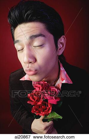 Man with bouquet of roses, eyes closed, preparing for a kiss View Large Photo Image Stock Photo - Man with bouquet of roses, eyes closed, preparing for a kiss. Fotosearch