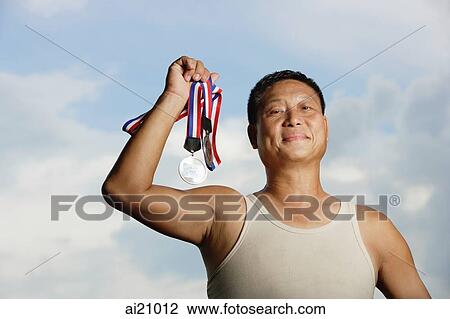 Mature adult in tank top, holding medals View Large Photo Image Stock Image - Mature adult in tank top, holding medals. Fotosearch