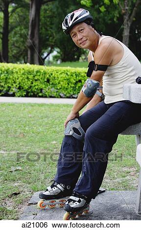 Mature adult with roller blades, sitting in park View Large Photo Image Stock Photograph - Mature adult with roller blades, sitting in park. Fotosearch