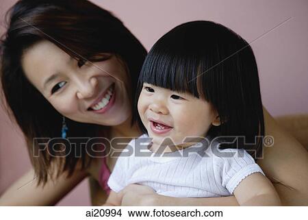 Mother with young daughter, smiling View Large Photo Image Picture - Mother with young daughter, smiling. Fotosearch