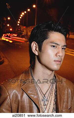 Young man wearing leather jacket and necklace, head shot View Large Photo Image Stock Image - Young man wearing leather jacket and necklace, head shot. Fotosearch