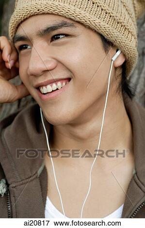 Young man with earphones View Large Photo Image Stock Photo - Young man with earphones. Fotosearch