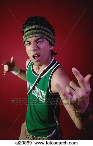 Young man with sweat band, making hand sign towards camera View Large Photo Image Stock Photo - Young man with sweat band, making hand sign towards camera. Fotosearch