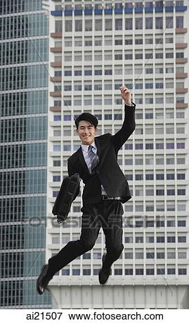 Businessman jumping in air, smiling View Large Photo Image Stock Photo - Businessman jumping in air, smiling. Fotosearch