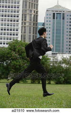 Businessman running through the park View Large Photo Image Stock Image - Businessman running through the park. Fotosearch