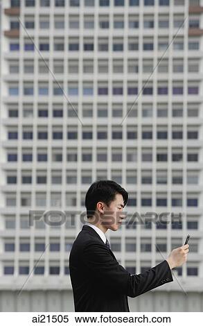 Businessman with mobile phone, side view View Large Photo Image Stock Photography - Businessman with mobile phone, side view. Fotosearch