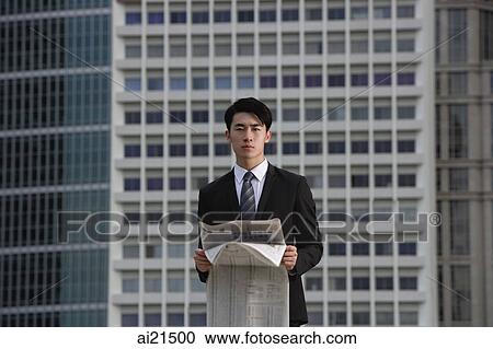 Businessman with newspaper, building in the background View Large Photo Image Stock Image - Businessman with newspaper, building in the background. Fotosearch