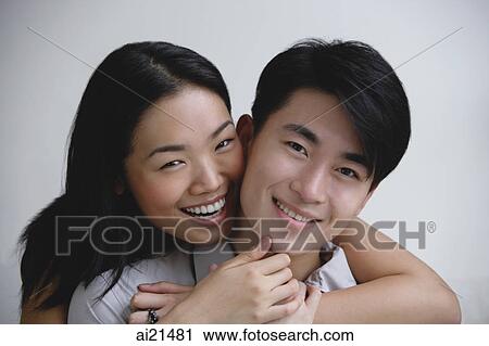 Couple embracing, smiling at camera View Large Photo Image Stock Image - Couple embracing, smiling at camera. Fotosearch