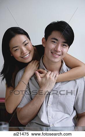 Couple embracing, smiling at camera View Large Photo Image Stock Photography - Couple embracing, smiling at camera. Fotosearch