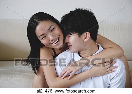 Couple embracing, woman smiling at camera View Large Photo Image Stock Photograph - Couple embracing, woman smiling at camera. Fotosearch