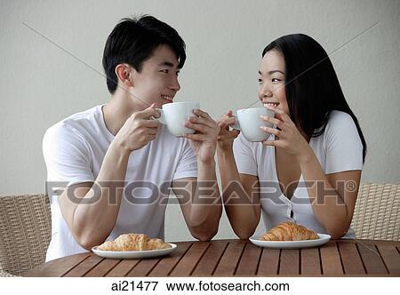 Couple having breakfast, smiling at each other View Large Photo Image Stock Photo - Couple having breakfast, smiling at each other. Fotosearch