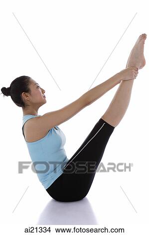 Female gymnast holding her ankles, stretching View Large Photo Image Picture - Female gymnast holding her ankles, stretching. Fotosearch