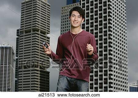 Man listening to MP3 player View Large Photo Image Stock Image - Man listening to MP3 player. Fotosearch