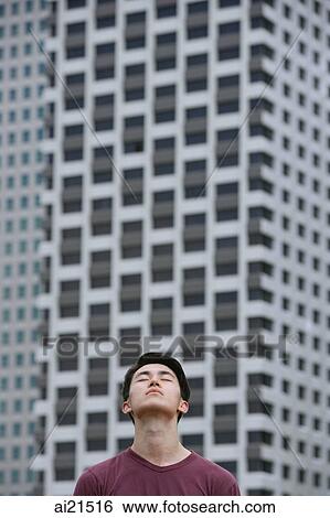 Stock Photograph - Man looking up, eyes closed. Fotosearch