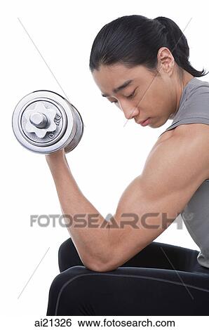 Stock Photograph - Man performing bicep curl with dumbbell. Fotosearch