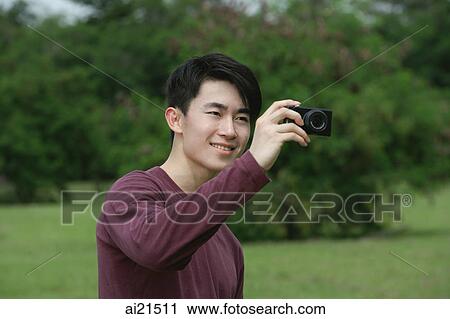 Man taking a picture with camera View Large Photo Image Stock Image - Man taking a picture with camera. Fotosearch
