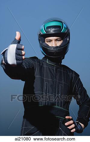 Race car driver in protective sportswear, making thumbs up sign View Large Photo Image Stock Image - Race car driver in protective sportswear, making thumbs up sign. Fotosearch